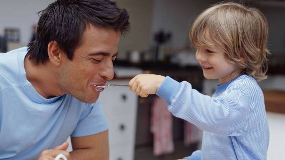 Child feeding father cereal