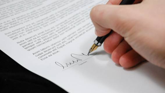 Hand signing paper